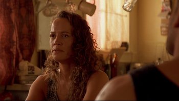 Movie still from “Once Were Warriors” (1994), directed by Lee Tamahori – A person sitting in a room near a window; Close Up shot, Over the shoulder angle