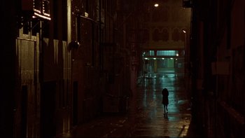 Movie still from “Once Were Warriors” (1994), directed by Lee Tamahori – A person walking down a dark street at night; Extreme Wide shot, High angle
