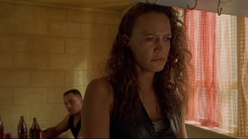 Movie still from “Once Were Warriors” (1994), directed by Lee Tamahori – A woman standing next to a man in a room; Close Up shot, Over the shoulder angle