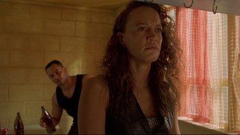 Movie still from “Once Were Warriors” (1994), directed by Lee Tamahori – A woman standing next to a man in front of a mirror; Close Up shot, Low angle
