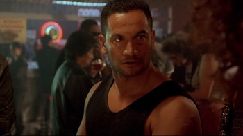 Movie still from “Once Were Warriors” (1994), directed by Lee Tamahori – A person wearing a tank top; Close Up shot, Over the shoulder angle