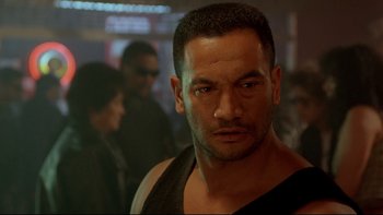 Movie still from “Once Were Warriors” (1994), directed by Lee Tamahori – A person wearing a tank top; Close Up shot, Over the shoulder angle