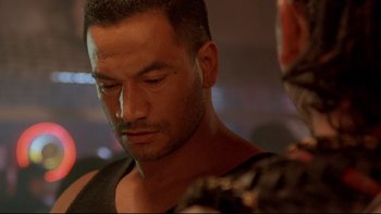 Movie still from “Once Were Warriors” (1994), directed by Lee Tamahori – A person wearing a black shirt; Close Up shot, Over the shoulder angle