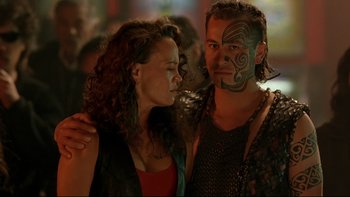 Movie still from “Once Were Warriors” (1994), directed by Lee Tamahori – A man and a woman standing next to each other; Close Up shot, Over the shoulder angle