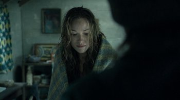 Movie still from “Ondine” (2009), directed by Neil Jordan – A woman wrapped in a blanket looking sad; Close Up shot, Over the shoulder angle