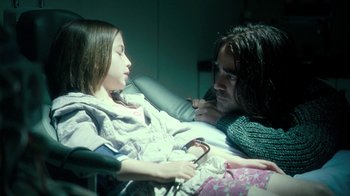 Movie still from “Ondine” (2009), directed by Neil Jordan – A man and a woman sitting in a hospital bed; Medium shot, High angle