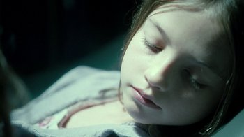 Movie still from “Ondine” (2009), directed by Neil Jordan – A young girl sleeping on top of a blanket; Close Up shot, High angle