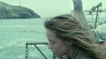 Movie still from “Ondine” (2009), directed by Neil Jordan – A young woman with long brown hair is on a boat in the ocean; Close Up shot, Over the shoulder angle