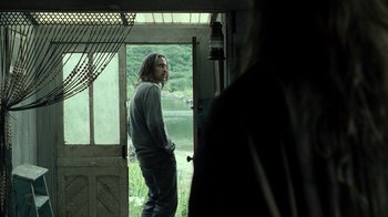 Movie still from “Ondine” (2009), directed by Neil Jordan – A man standing in front of an open door; Medium shot, Over the shoulder angle