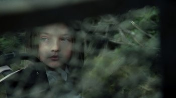 Movie still from “Ondine” (2009), directed by Neil Jordan – A young girl looking out of a car window; Close Up shot, Over the shoulder angle