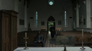 Movie still from “Ondine” (2009), directed by Neil Jordan – A man sitting on a bench in a church; Wide shot, Low angle