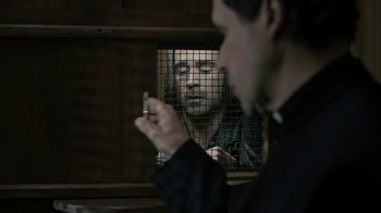 Movie still from “Ondine” (2009), directed by Neil Jordan – A man smoking a cigarette in front of a mirror; Close Up shot, Over the shoulder angle