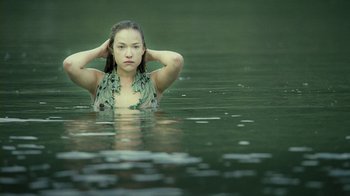 Movie still from “Ondine” (2009), directed by Neil Jordan – A woman in the water with her hands behind her head; Medium shot, High angle
