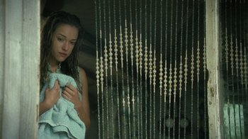 Movie still from “Ondine” (2009), directed by Neil Jordan – A woman holding a towel in front of a window; Close Up shot, High angle