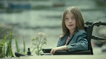 Movie still from “Ondine” (2009), directed by Neil Jordan – A young girl sitting at a table in a restaurant; Medium shot, High angle