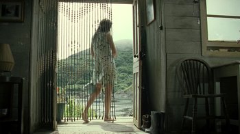 Movie still from “Ondine” (2009), directed by Neil Jordan – A woman standing at the entrance of a house; Wide shot, Low angle