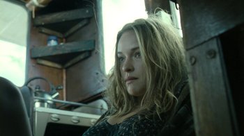 Movie still from “Ondine” (2009), directed by Neil Jordan – A woman sitting in a chair looking at the camera; Close Up shot, Low angle