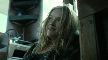 Movie still from “Ondine” (2009), directed by Neil Jordan – A woman with long blonde hair sitting in a chair; Close Up shot, Low angle