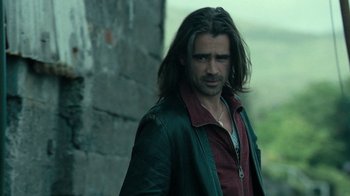 Movie still from “Ondine” (2009), directed by Neil Jordan – A man with long hair standing in front of a brick wall; Close Up shot, Over the shoulder angle