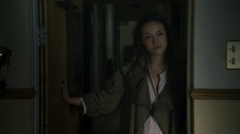 Movie still from “Ondine” (2009), directed by Neil Jordan – A young woman is standing in a doorway; Medium shot, Over the shoulder angle