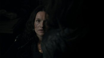 Movie still from “Ondine” (2009), directed by Neil Jordan – A woman in a dark room looking at the camera; Close Up shot, Over the shoulder angle