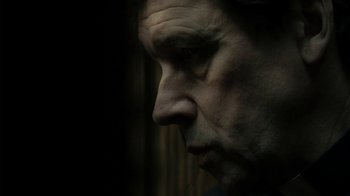 Movie still from “Ondine” (2009), directed by Neil Jordan – A man's face in the dark; Close Up shot, Low angle