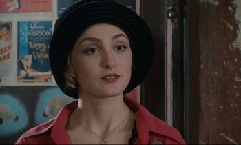 Movie still from “One Hundred and One Nights” (1995), directed by Agnès Varda – A person wearing a hat; Close Up shot, Over the shoulder angle