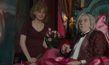 Movie still from “One Hundred and One Nights” (1995), directed by Agnès Varda – An older man sitting next to a young woman; Medium shot, Over the shoulder angle