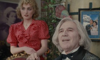 Movie still from “One Hundred and One Nights” (1995), directed by Agnès Varda – A man and a woman sitting next to each other; Medium shot, Over the shoulder angle