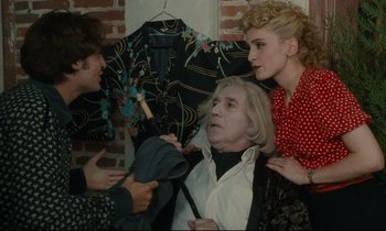 Movie still from “One Hundred and One Nights” (1995), directed by Agnès Varda – A group of people standing next to each other in a room; Medium shot, Over the shoulder angle