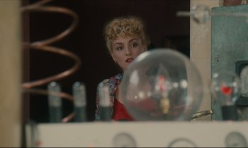 Movie still from “One Hundred and One Nights” (1995), directed by Agnès Varda – A woman sitting in front of a mirror looking at herself in the mirror; Close Up shot, Over the shoulder angle