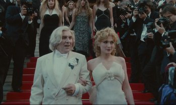 Movie still from “One Hundred and One Nights” (1995), directed by Agnès Varda – A man and a woman in a white dress; Medium shot, Low angle