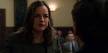 Movie still from “13 Reasons Why” (2017), created by Brian Yorkey – A woman in a green shirt is talking to a man in a suit and tie; Close Up shot, Over the shoulder angle