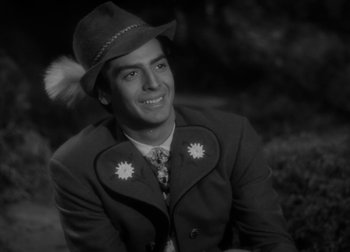 Movie still from “One Million B.C.” (1940), directed by Hal Roach Jr. – A black and white photo of a man wearing a hat; Close Up shot, Over the shoulder angle