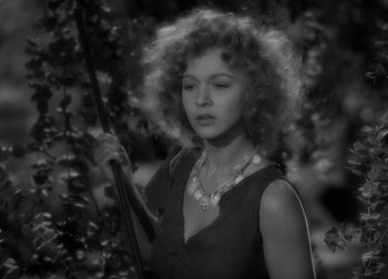 Movie still from “One Million B.C.” (1940), directed by Hal Roach Jr. – A black and white photo of a woman holding a cane; Close Up shot, High angle