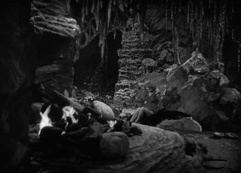 Movie still from “One Million B.C.” (1940), directed by Hal Roach Jr. – A black and white photo of a cave; Wide shot, High angle