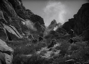 Movie still from “One Million B.C.” (1940), directed by Hal Roach Jr. – A black and white photo of a group of animals in a field; Extreme Wide shot, High angle