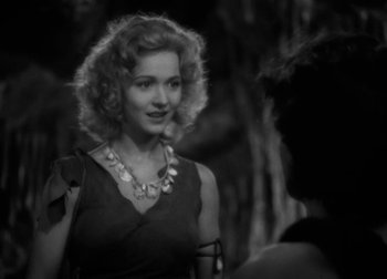 Movie still from “One Million B.C.” (1940), directed by Hal Roach Jr. – A black and white photo of a woman in a black dress; Close Up shot, Over the shoulder angle