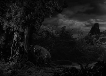 Movie still from “One Million B.C.” (1940), directed by Hal Roach Jr. – A black - and - white photo of a tree and a river; Extreme Wide shot, Low angle