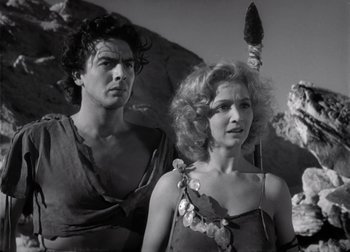 Movie still from “One Million B.C.” (1940), directed by Hal Roach Jr. – A man and a woman standing next to each other; Medium shot, Low angle