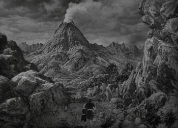 Movie still from “One Million B.C.” (1940), directed by Hal Roach Jr. – A black - and - white photo of a mountain range; Extreme Wide shot, High angle