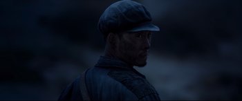 Movie still from “One Second” (2020), directed by Yimou Zhang – A person wearing a hat; Close Up shot, Low angle