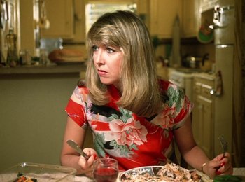 Movie still from “One from the Heart” (1981), directed by Francis Ford Coppola – A woman sitting at a table with a plate of food in front of her; Close Up shot, High angle