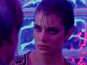 Movie still from “One from the Heart” (1981), directed by Francis Ford Coppola – A person wearing makeup on their face; Close Up shot, Over the shoulder angle