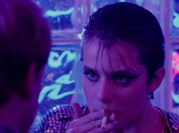 Movie still from “One from the Heart” (1981), directed by Francis Ford Coppola – A woman smoking a cigarette in front of another woman; Close Up shot, Over the shoulder angle