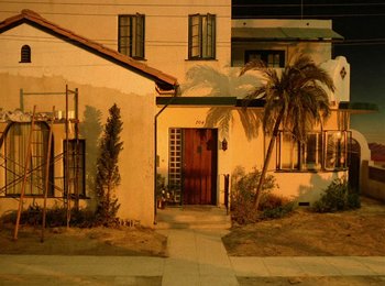 Movie still from “One from the Heart” (1981), directed by Francis Ford Coppola – A house with a palm tree in front of it; Extreme Wide shot, High angle