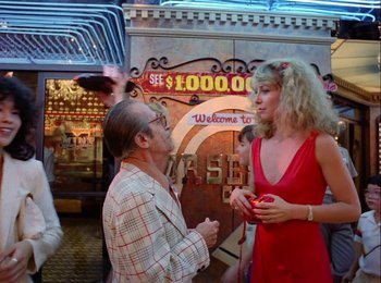 Movie still from “One from the Heart” (1981), directed by Francis Ford Coppola – A man and a woman talking in front of a building; Wide shot, Over the shoulder angle