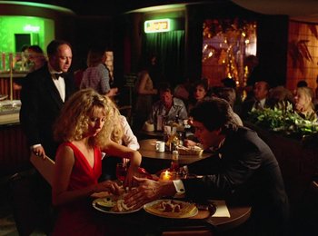 Movie still from “One from the Heart” (1981), directed by Francis Ford Coppola – A man and a woman sitting at a dinner table; Wide shot, Over the shoulder angle