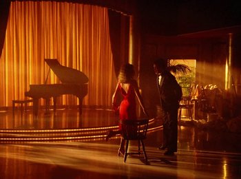 Movie still from “One from the Heart” (1981), directed by Francis Ford Coppola – A man and a woman are standing in front of a stage; Wide shot, High angle