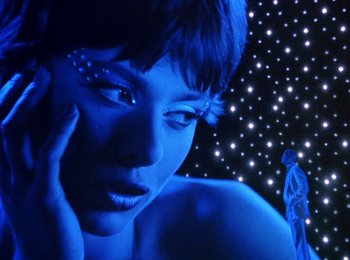 Movie still from “One from the Heart” (1981), directed by Francis Ford Coppola – A woman's face in front of a star - filled background; Close Up shot, Low angle